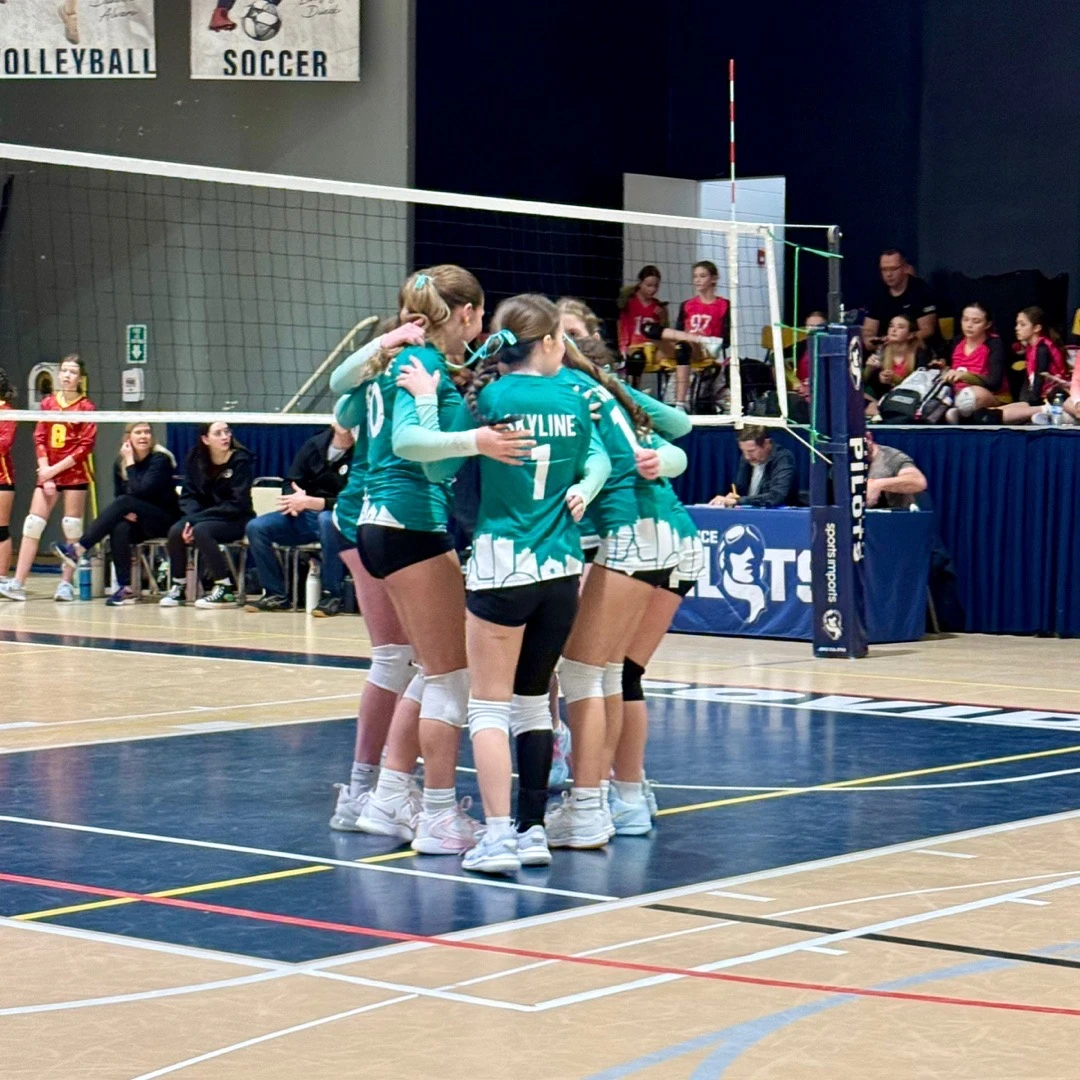 Skyline athletes competing at the net during a match