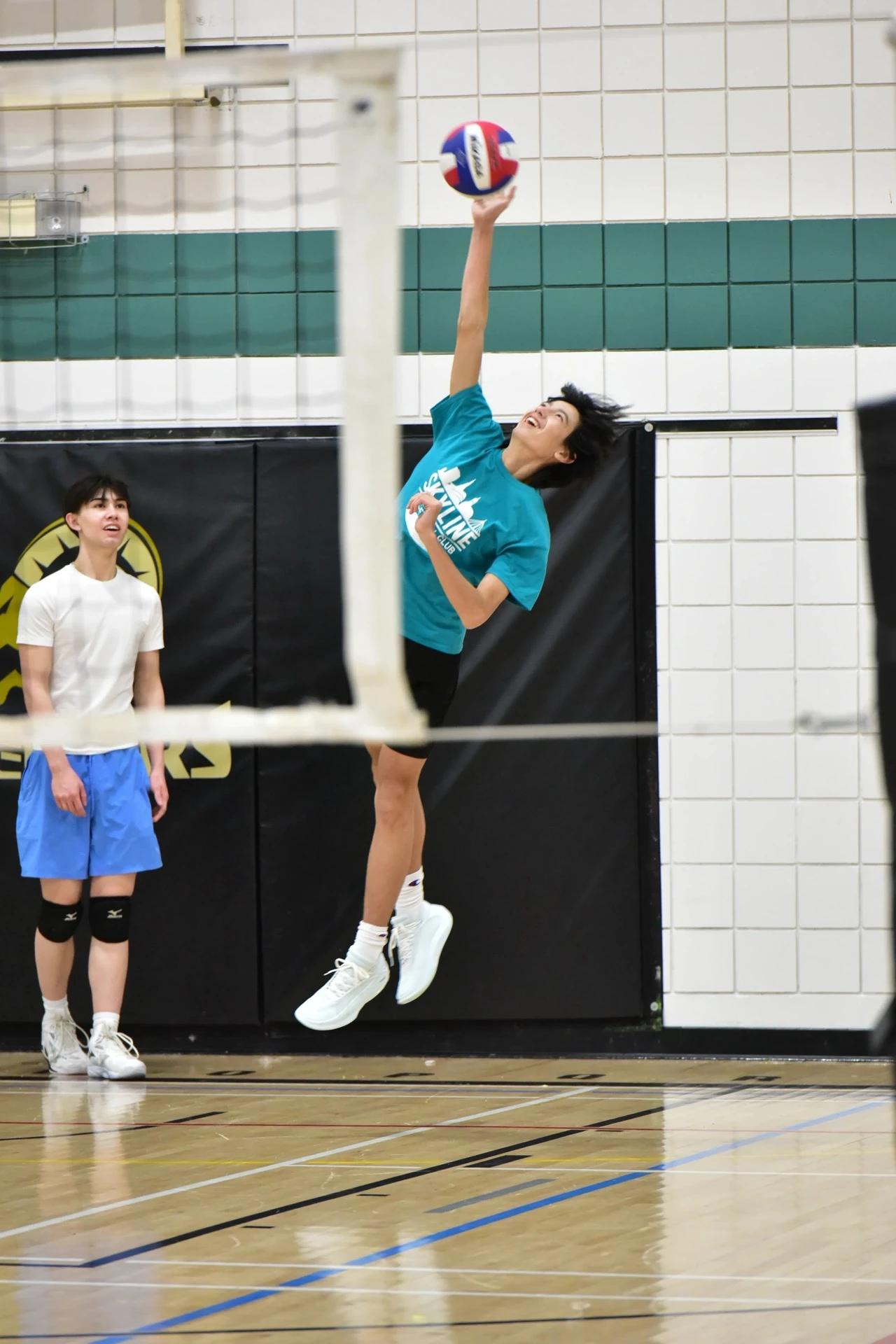 Skyline athlete jumping to hit during training